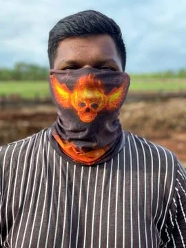 A boy wear a face mask to avoid Corona virus. Pandemic in India. Stock Photos