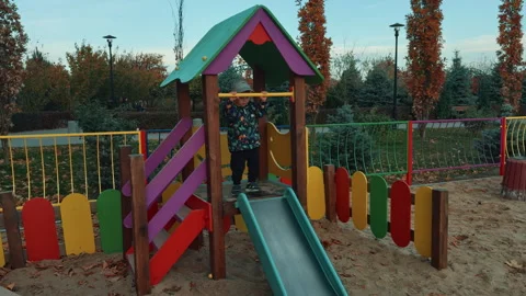 Boy wearing jacket and cap waving on the horizontal bar. Stock Footage 255009360