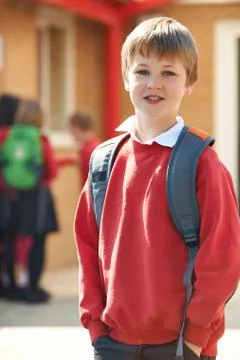 Boy Wearing Uniform Standing In School Playground Stock Photos