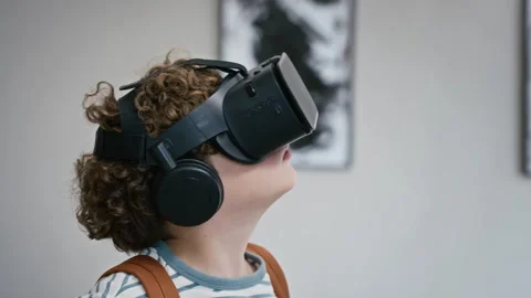 Boy Wearing Virtual Reality Headset Gesturing in Art Gallery Stock Footage 343612029