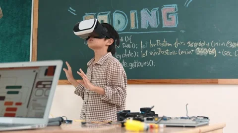 Boy wearing VR headset to enter metaworld while girl coding system. Pedagogy. Stock Footage 266754112