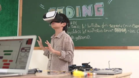 Boy wearing VR headset to enter metaworld while girl coding system. Pedagogy. Stock Footage 281684004