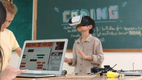 Boy wearing VR headset to enter metaworld while girl coding system. Pedagogy. Stock Footage 283863287