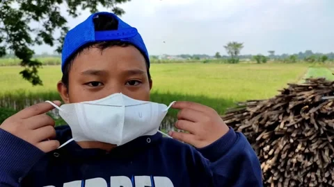 A boy wearing a white mask Stock Footage 204892898