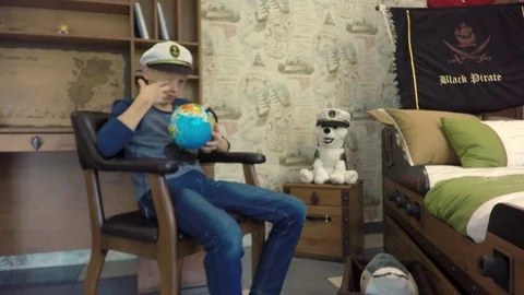 The boy wears a captain's cap. Video stock 80014583
