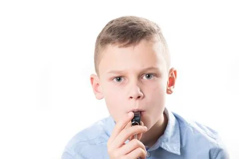 Boy with whistle on white background Stock Photos
