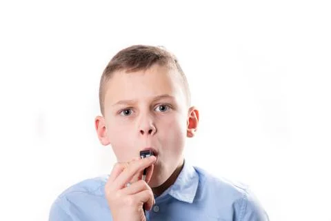 Boy with whistle on white background Stock Photos
