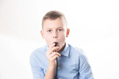 Boy with whistle on white background Stock Photos
