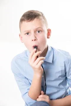 Boy with whistle on white background Stock Photos