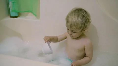 Boy in white bath with foam Stock Footage 74678424