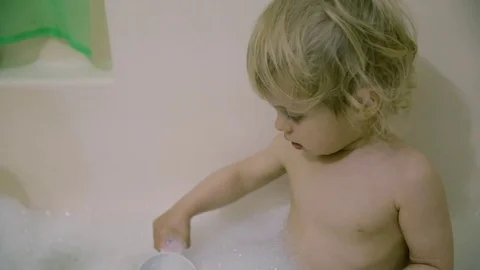 Boy in white bath with foam Stock Footage 74713440
