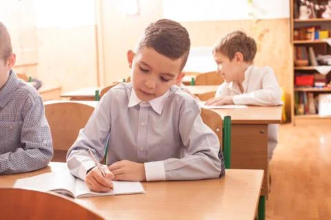 Boy white in the copybook Stock Photos