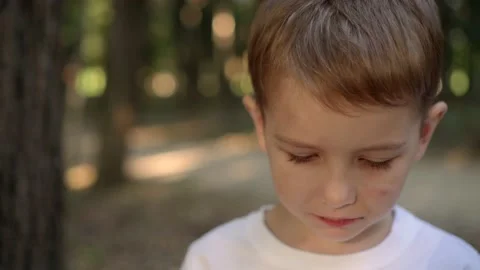 Boy in a white shirt eats cookies Stock Footage 139209103