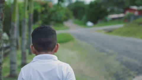 Boy in white sweater walking backwards, medium shot Stock Footage 201581920