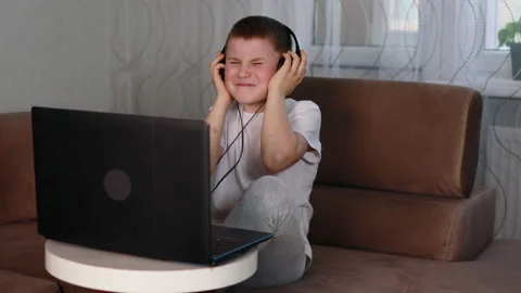 Boy in white t-shirt in headphones listening music Stock Footage 153579110
