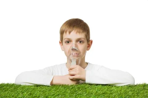 Boy in white using inhalator mask Stock Photos