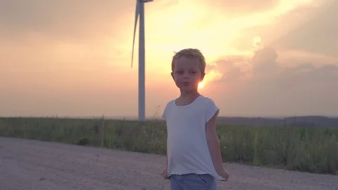 Boy in wind turbines field Stock Footage 91353745