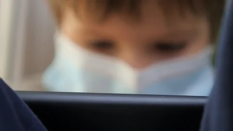 Boy on windowsill playing game. E-learning, home school background. Children and Stock Footage 129063281
