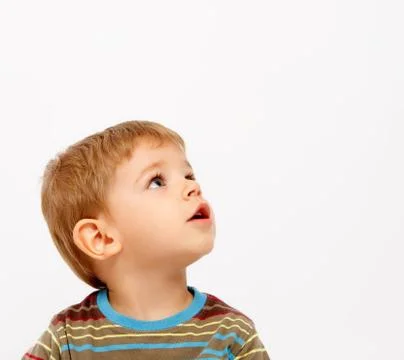 Boy in winter clothes looking up Stock Photos