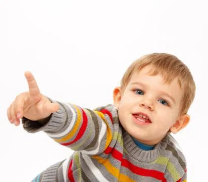 Boy in winter clothes pointing Stock Photos