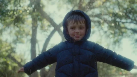 Boy in a winter jacket in the rain Stock Footage 279081415