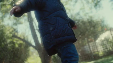 Boy in a winter jacket in the rain Stock Footage 279150652