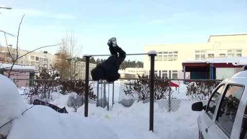 Boy in winter rotation on the crossbeam Stock Footage 77266494