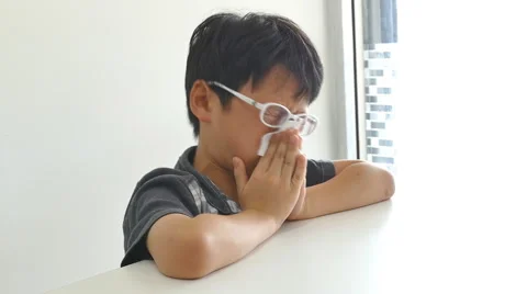 Boy wipes his snot by tissue paper Stock Footage 56607348
