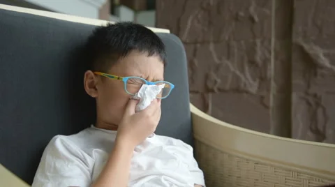 Boy wipes his snot by tissue paper Stock Footage 67580183