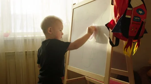 Boy Wiping off Scribbles from the Marker Board 스톡 동영상 60360950