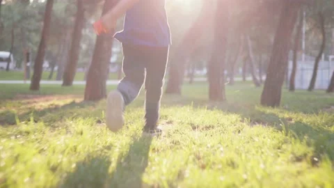 Boy without face running in the park with trees against of sunset. Happy child Stock Footage 200478418