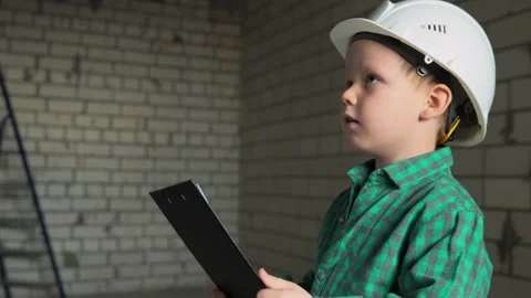 The boy is working, checking the completed work on the construction site Stock Footage 238620421
