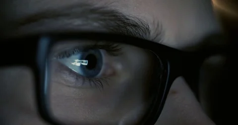 Boy working at a computer in a dark room, surfing the Internet, close-up Vídeo Stock 74227899