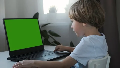 Boy working on a computer at home. E-lessons, education for kids. Stock Footage 120323691
