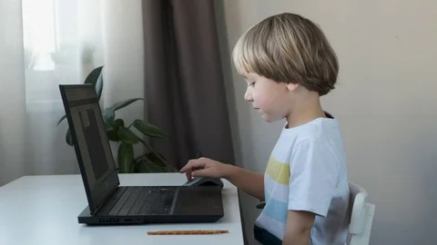 Boy working on a computer, programming, learning or playing Stock Footage 120666450