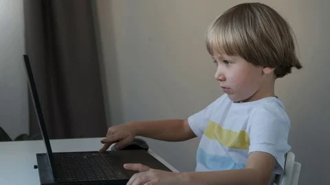Boy working on a computer, programming, learning or playing Vídeos de archivo 120717360