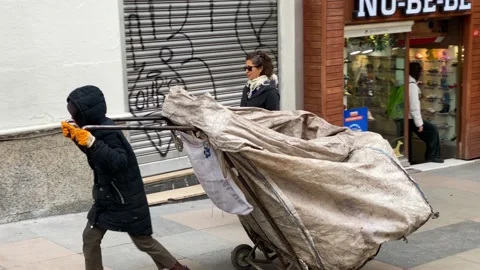 A boy working as Garbage collector is seen in Kadikoy, Istanbul, Turkey 4K Stock Footage 169405646