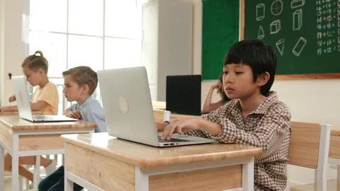 Boy working on his laptop while learning about coding prompt at class. Pedagogy. Foto stock