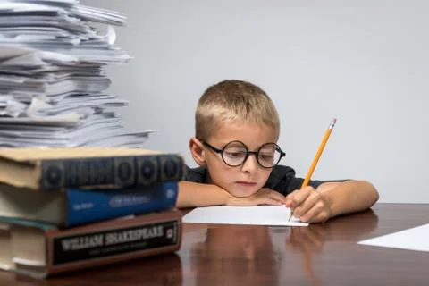 Boy Working on  his Stack of Advanced Homework Foto stock