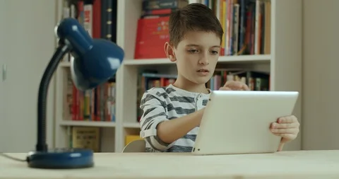 Boy working at home on digital tablet. Stock Footage 127844696