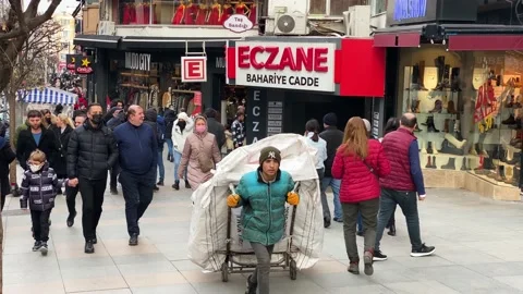 Boy working as a trash collector pulls a cart in Istanbul, Turkey 4K Stock Footage 169405610