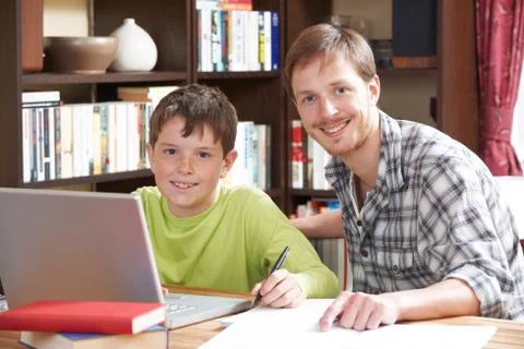Boy Working At With Tutor At Home Stock Photos