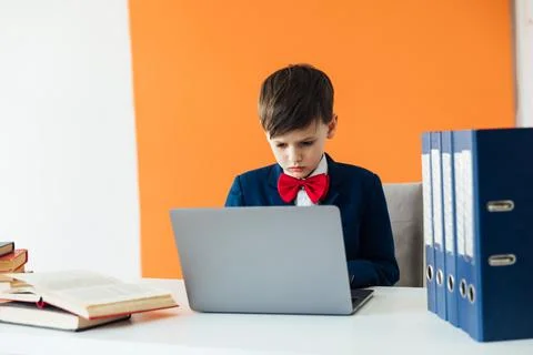 A boy works at a laptop in a computer lab education learning programming Stock Photos