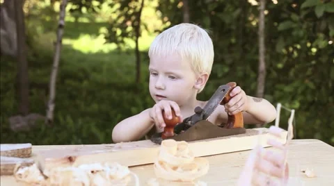  boy in the workshop of a carpenter planed wood planers  Stock Footage 65797413