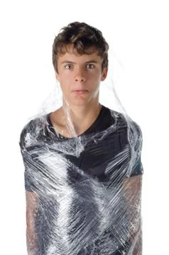 Boy wrapped in shrinkwrap cellophane Stock Photos