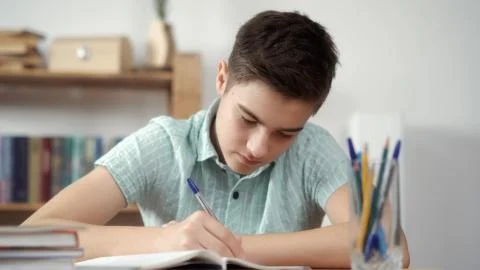 Boy writes and does the lessons Stock Photos