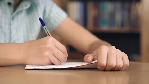Boy writes and thinks Stock Footage