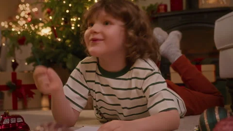 Boy writes a letter with wish list to Santa Claus Stock Footage 260910562