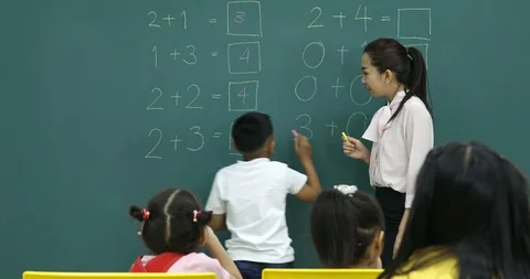 Boy writes the Math problem answer on green board. Stock Footage 101092139