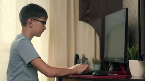 Boy writes program code at home using computer Stock Footage 236637977